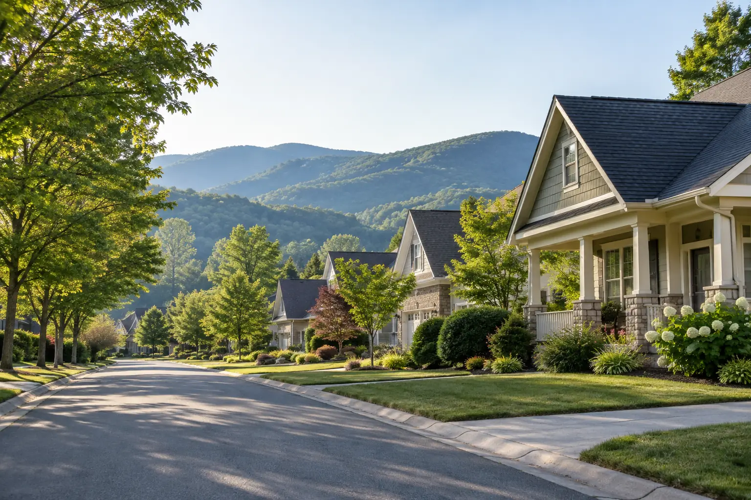 Tree-lined residential street with mountain ridges behind in Fletcher, NC